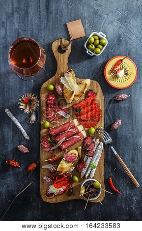 Tapas sausage mix from Spain jamon iberico lomo cheese ham chorizo olives.