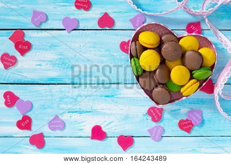 Frame Valentine's Day Or A Birthday, Mother's Day. Gifts Makarons Cake With Heart On A Blue Wooden B