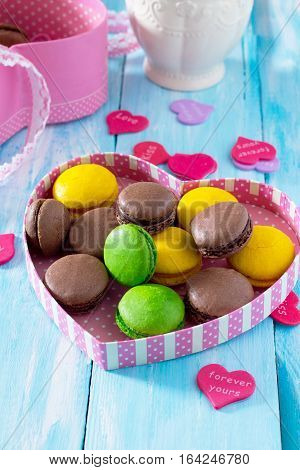 Frame Valentine's Day Or A Birthday, Mother's Day. Gifts Makarons Cake With Heart On A Blue Wooden B