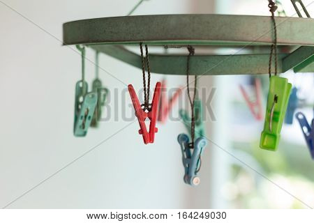 Clothes pegs or clothespins hang on a cord. Plastic clothes pegs on a washing line.(selective focus)