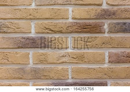 Brick background abstract weathered texture of stained old light brown stucco and painted red yellow brick wall background in rural room Grungy rusty blocks of stonework tech dark retro color architecture Wallpaper.