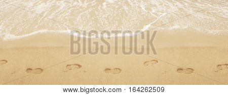 Trail shoes on the san. Surf on the beach. Sea shore