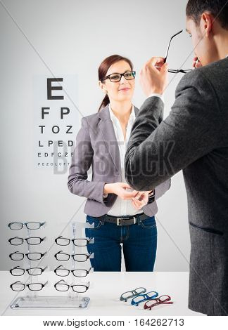 Customer trying new glasses at the optician's.
