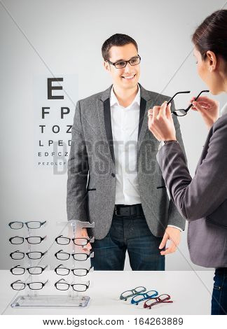 Customer trying new glasses at the optician's.