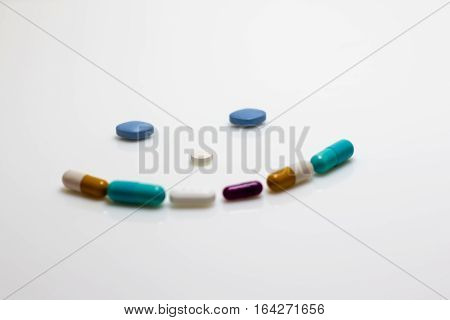 Concept image of a smiley face made of pills.