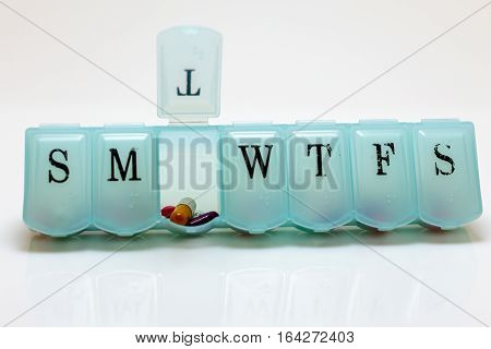 A pill box with Tuesday's pills visible.