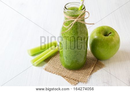 Healthy celery smoothie with green apple in bottle. Green smoothie for weight loss and detox selective focus horizontal