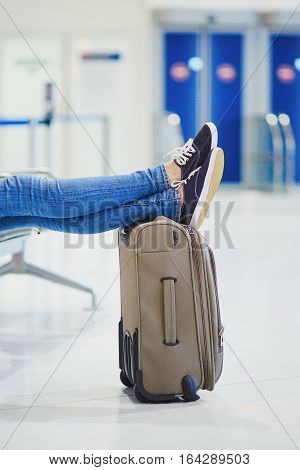 Closeup Of Woman Feet On A Suitcase In International Airport