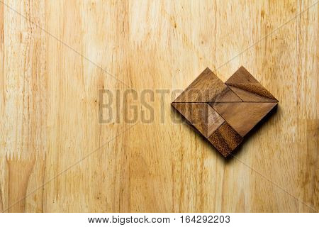 Wooden tangram puzzle in heart shape (Concept for love)