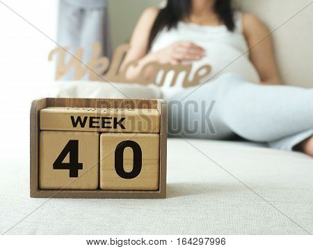 Calendar with weeks 40 of pregnant with pregnancy woman background. Maternity concept. Expecting an upcoming baby. Due date countdown.