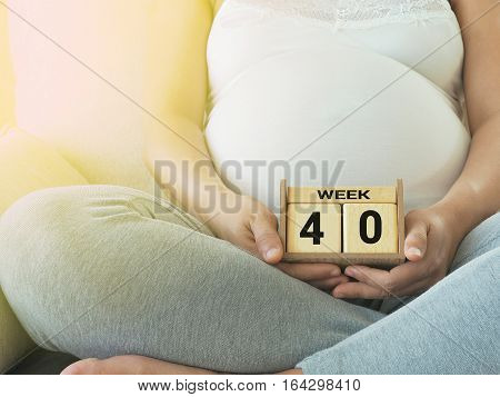 Calendar with weeks 40 of pregnant with pregnancy woman background. Maternity concept. Expecting an upcoming baby. Due date countdown.