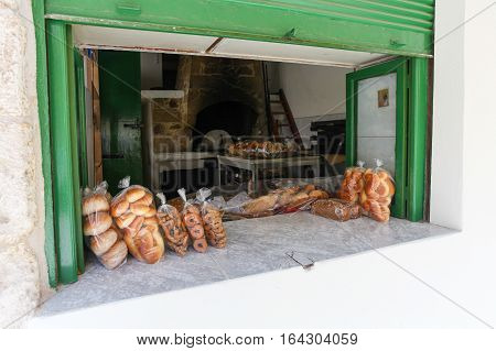 Rethymnon, Island Crete, Greece- July 1 2016: Window of bakery with fresh and tasty muffins pastry and bread on the street of the old town's part of city Rethymnon