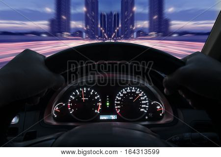 Driving at a speed of 180 km / h on the highway against the background of the city.