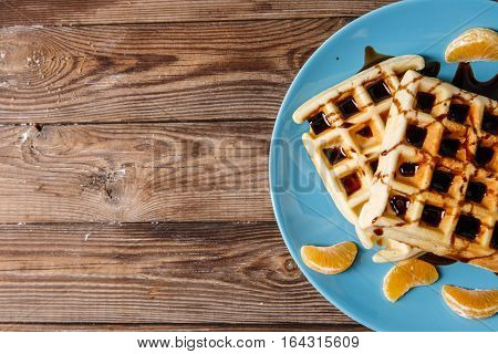 Photo of home waffles on blue plate
