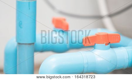 Blue water pipe and red valves with background