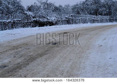 winter road in the bitter cold on the outskirts of the city in the park