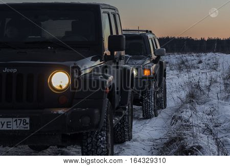 The river Tosno, Leningrad oblast, Russia - January 07, 2017, Hammer H3 and Jeep Wrangler Jk on the shore of the river, the Hummer H3 is a compact SUV produced by GM