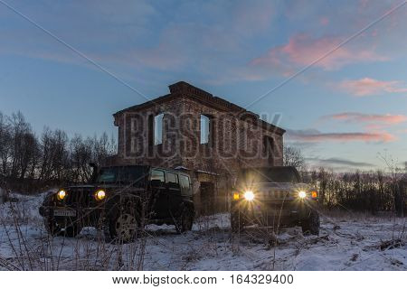 The river Tosno, Leningrad oblast, Russia - January 07, 2017, Hammer H3 and Jeep Wrangler Jk on the shore of the river, the Hummer H3 is a compact SUV produced by GM