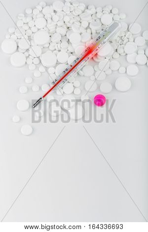 Bunch Of White Tablets With Thermometer. Scattered Pills.