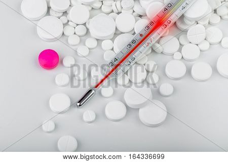 Bunch Of White Tablets With Thermometer. Scattered Pills.