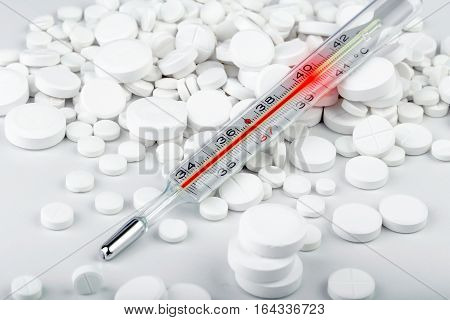 Bunch Of White Tablets With Thermometer. Scattered Pills.