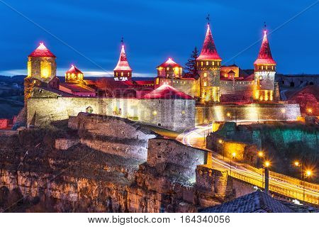 Scenic night view of ancient fortress castle in Kamianets-Podilskyi, Khmelnytskyi Region, Ukraine