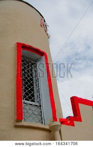 zareshotchatoe window with orange stripe  stripe on brown wall