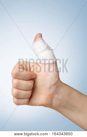 Injured painful finger with white gauze bandage