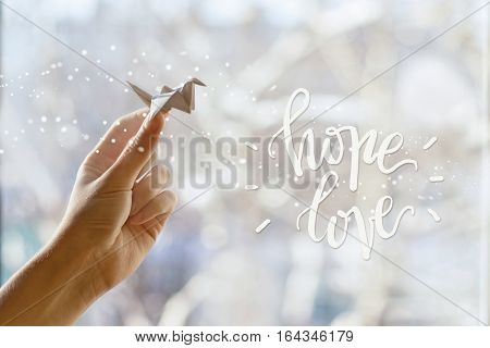 Fabulous paper crane in your hand. Hope Love
