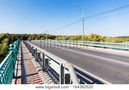 Fenced sidewalk on the empty bridge in Russia