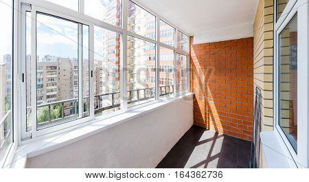 The new glazed balcony with brick wall