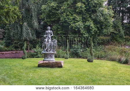Landgraaf, Netherlands - July 12, 2016: Elegant statue in the English garden of park Mondo Verde