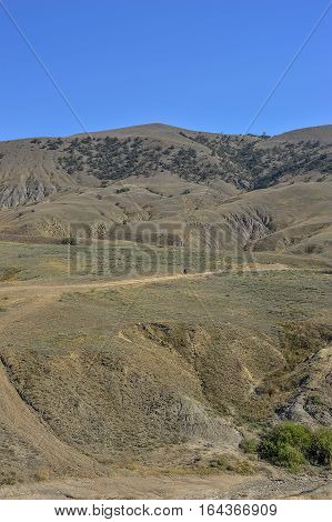 Russia peninsula of Crimea near Sudak. Tract Kapsel - scorched southern sun endless hills.