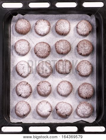 Ready-made chocolate cookies on a baking sheet top view