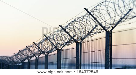 Sharp Barbed Wire On Fence
