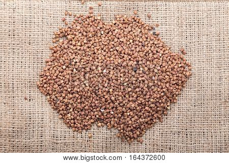 raw buckwheat scattered on the sacking useful dietary cereal