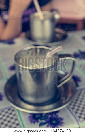 Closeup of pink straw ready to drink smoothie. Fresh fruit juice in metal cup.