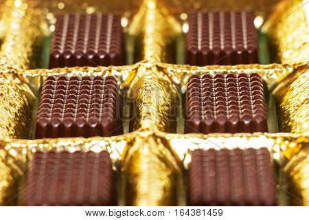 Chocolates in gold are in the box