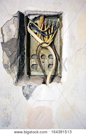 Exposed wire in the electrical wiring in the wall