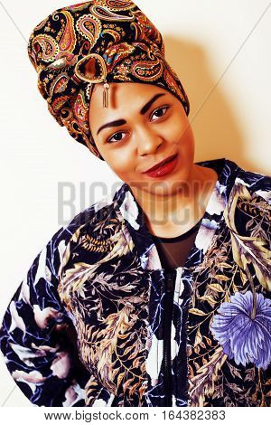 beauty bright african woman with creative make up, shawl on head like cubian closeup smiling, cheerful tan , lifestyle people concept close up