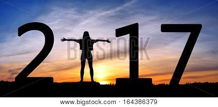 Silhouette young woman jumping on the sea and 2017 years while celebrating new EAP, 2017, happy girl. silhouette of girl at sunset, jumping on the background of sunset