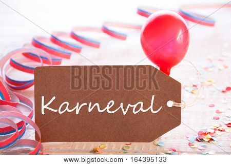 One Label With German Text Karneval Means Carnival. Party Decoration Like Streamer, Confetti And Balloon. Wooden Background With Vintage, Retro Or Rustic Syle