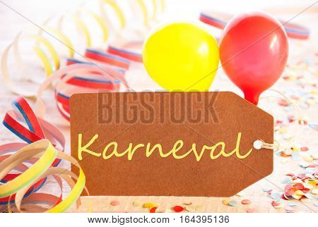 One Label With German Text Karneval Means Carnival. Party Decoration Like Streamer, Confetti And Balloons. Wooden Background With Vintage, Retro Or Rustic Syle