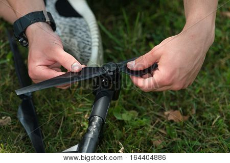 Man Tightening Drone Propeller In Nature