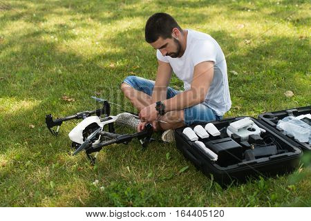 Man Tightening Drone Propeller In Nature