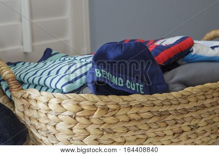 a close-up view of a basket full of baby clothes