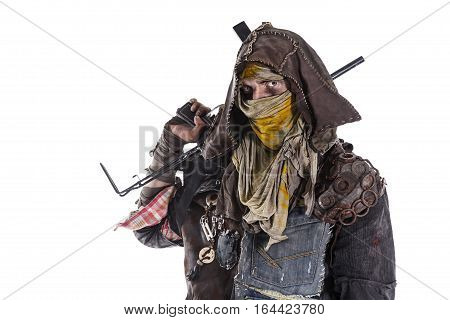Nuclear post apocalypse life after doomsday concept. Grimy survivor with homemade weapons. Studio closeup portrait on white background
