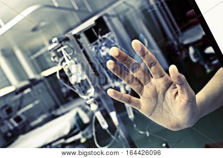 Patient in hospital pressed his hand to the glass asking help.