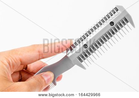 Hand woman holding Comb slice hair with blade isolated on white background.