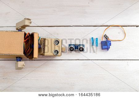 robot screwdrivers and servo  on a wooden white table. View from above